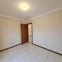 Corredor com porta de madeira em um imóvel.