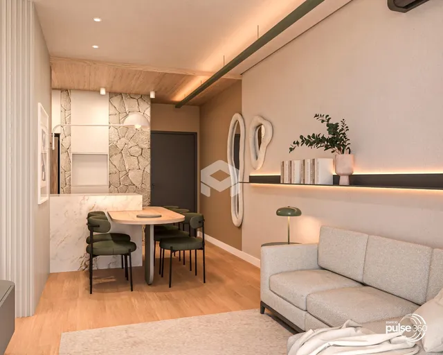 Sala de estar com mesa de jantar e sofá em um apartamento em Lajeado.