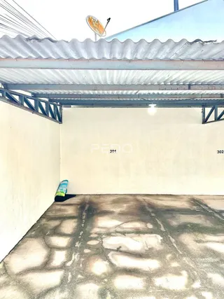 Foto de um espaço interno com teto de metal e piso de concreto.