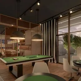 Sala com mesa de sinuca e grandes janelas.