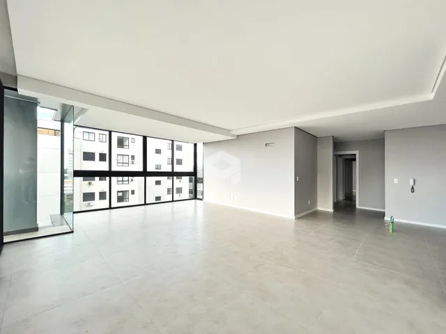 Espaço interno amplo com piso claro e paredes brancas.