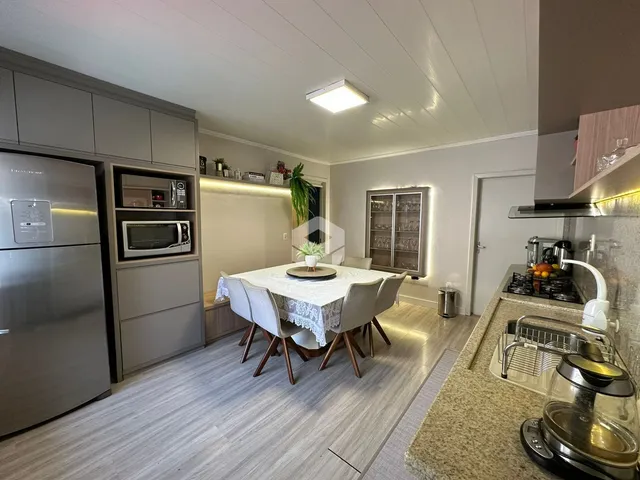 Uma sala de jantar com mesa e cadeiras em um apartamento.