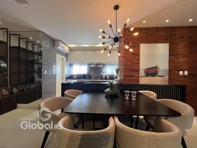 Sala de jantar com cozinha e parede de tijolos na Lajeado.