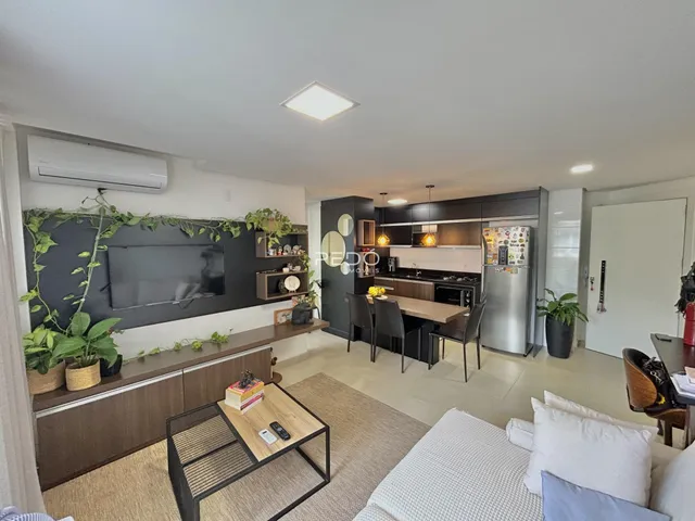 Sala de estar com decoração moderna e cozinha integrada.