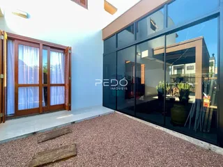 Ambiente interno com portas de vidro que dão acesso a uma área externa.