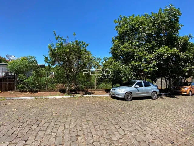 Vista externa da propriedade com árvores e estacionamento.