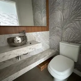 Foto de um banheiro com bancada e vaso sanitário em um imóvel.