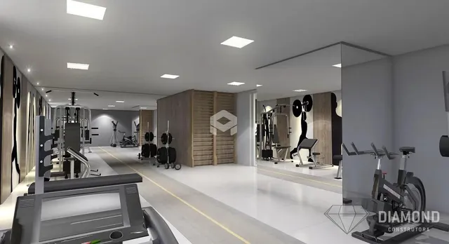 Interior de uma academia moderna com equipamentos de musculação e piso claro.