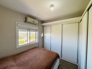 Quarto com cama e armários em um apartamento.