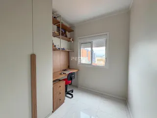 Interior de um ambiente com estantes de madeira e uma janela.