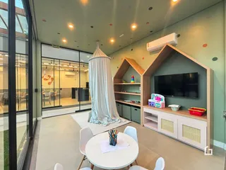 Sala de estar com decoração moderna e grandes portas de vidro.