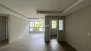 Ambiente interno de uma sala ampla com paredes brancas.