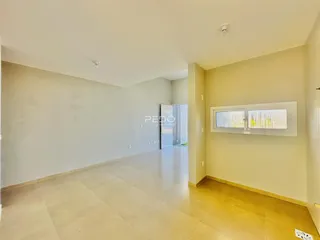 Hall de uma propriedade em Lajeado, Brasil, com paredes brancas e piso claro.