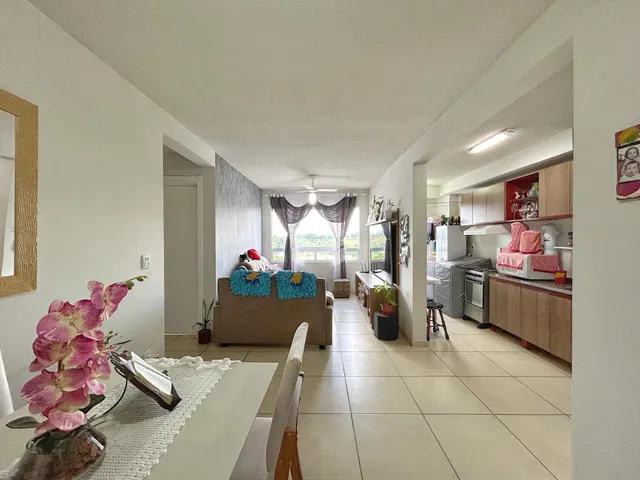 Interior de uma sala de estar com passagem para a cozinha em um imóvel no Brasil.