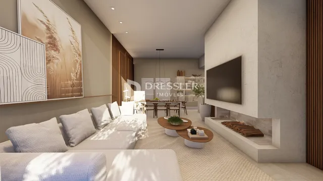 Sala de estar moderna com sofá e decoração em um ambiente claro.