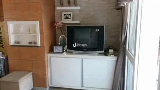 Sala de estar com parede de tijolos laranjas e móveis brancos.