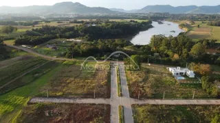 Vista aérea de uma propriedade rural com campos verdes e vegetação.