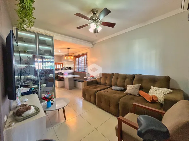 Sala de estar com sofá e televisão em um imóvel no Brasil.