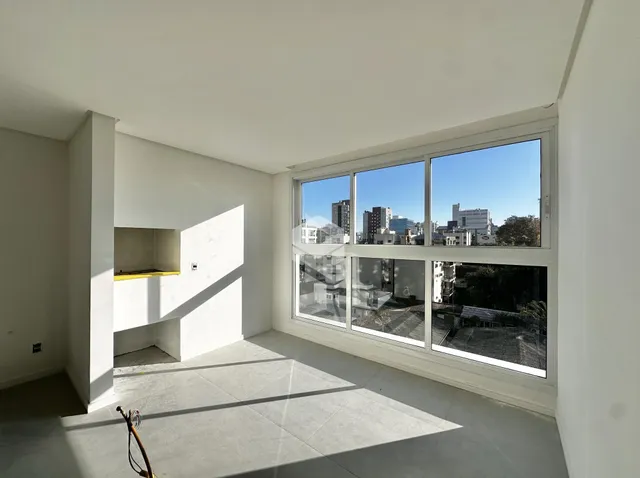 Vista interna de um ambiente com grande janela de vista para a cidade.