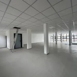 Foto de um ambiente interno amplo com teto de grid branco.
