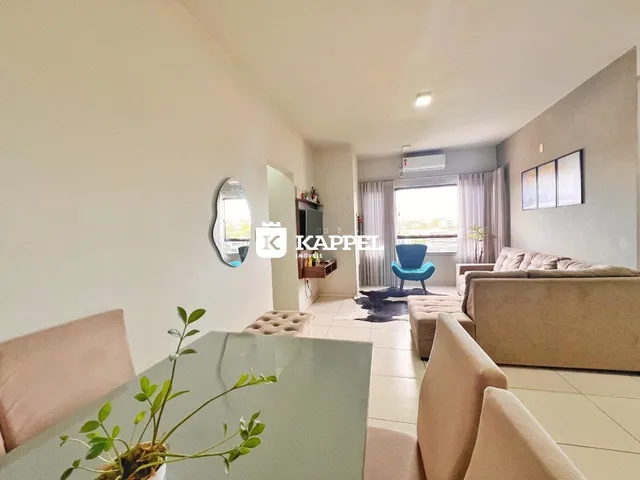 Sala de estar com sofá e mesa de vidro em um apartamento.