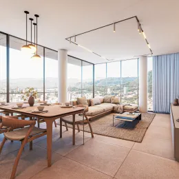 Sala de estar com grandes janelas que proporcionam uma vista panorâmica da paisagem urbana.