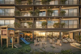 Fachada de um edifício residencial moderno com área externa e playground.