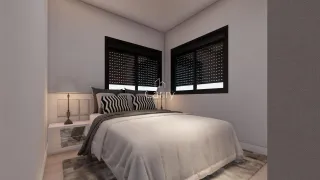 Um quarto com cama e janelas escuras.