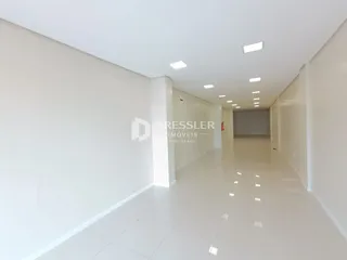 Corredor interno de uma residência com paredes brancas.