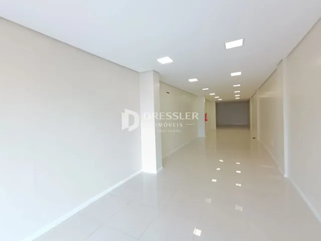 Corredor interno de uma residência com paredes brancas.