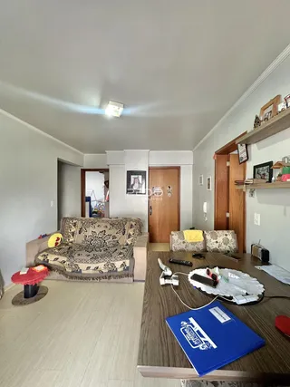 Sala de estar com sofá e piso de madeira clara.