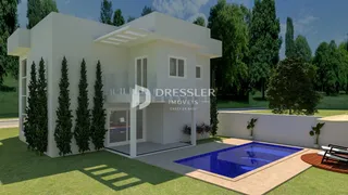 A fachada de uma casa moderna em Lajeado, Brasil, com piscina e jardim.