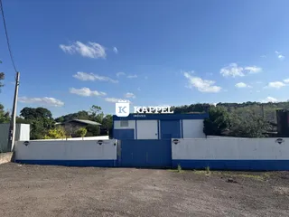 Foto da fachada de um imóvel com cerca azul e branca em Lajeado.