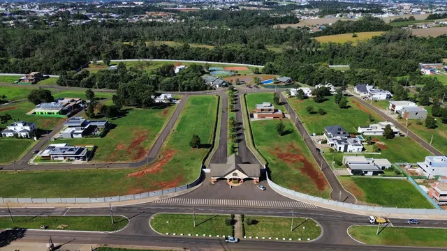 Vista aérea de uma área residencial com casas e terrenos verdes em Lajeado, Brasil.