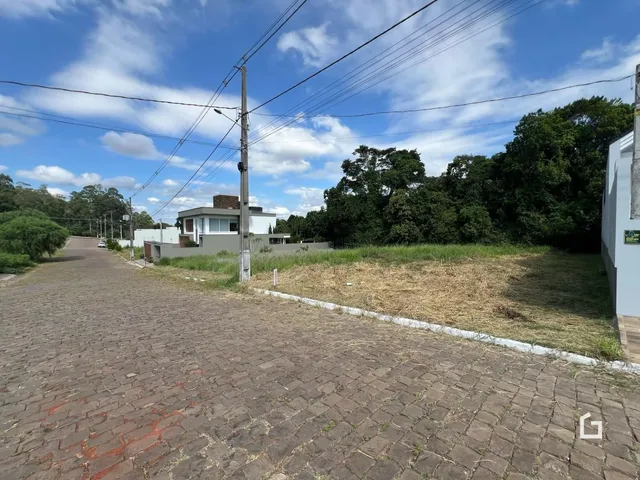 Vista da fachada de uma residência em Lajeado, Brasil, com uma rua de paralelepípedos em primeiro plano.