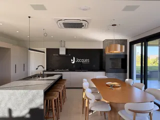 Uma cozinha moderna com ilha e mesa de jantar em um imóvel.