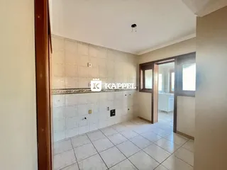 Vista de uma área interna com revestimento de azulejos brancos na parede.
