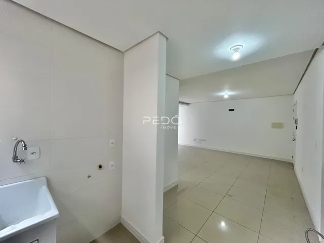 Foto de um banheiro com piso de cerâmica e paredes brancas em uma residência.
