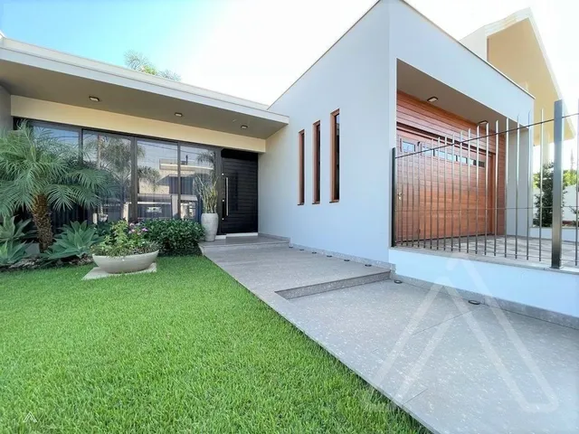 Fachada moderna de uma residência em Lajeado com jardim gramado em primeiro plano.