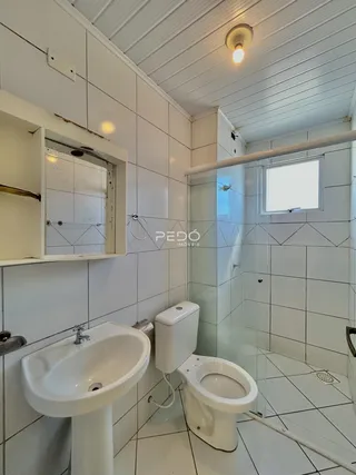 Banheiro com piso cerâmico e box de vidro