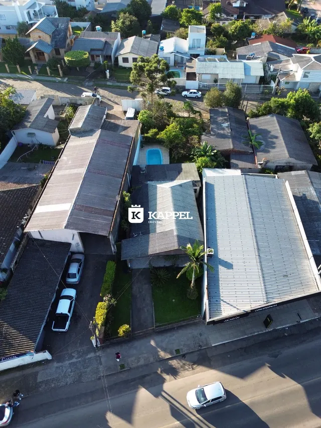 Vista aérea de um bairro residencial com várias casas e áreas verdes.