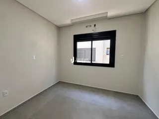 Ambiente interno com paredes brancas e piso de cerâmica em uma residência.