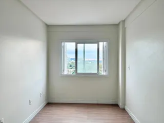 Sala de estar com grande janela oferecendo vista da paisagem.