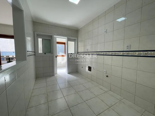 Hall de corredor com piso e paredes revestidos de cerâmica.