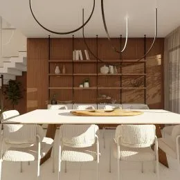 Uma sala de jantar com mesa e cadeiras de estofamento claro.