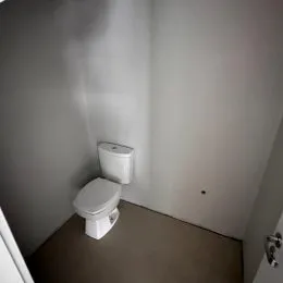 Foto de um banheiro mostrando um vaso sanitário branco.