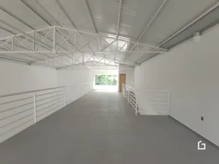 Vista interna de um ambiente com teto de estrutura exposta.