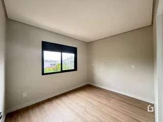 Sala de estar com piso de madeira e janela.