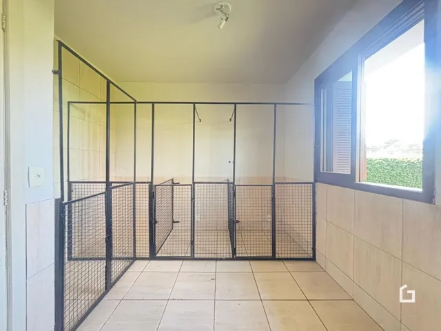 Interior com divisórias de metal e piso de cerâmica.