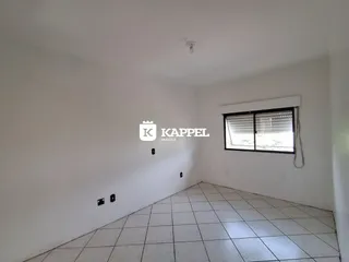 Uma foto de um cômodo vazio com piso de cerâmica e uma janela.